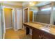 Bathroom with granite countertop vanity, framed mirror, tiled floors, and enclosed shower at 1720 Reflection Ln, St Cloud, FL 34771
