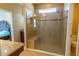 This bathroom features a large glass enclosed shower, a bench, and neutral colored tile at 1720 Reflection Ln, St Cloud, FL 34771