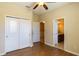 Bedroom with wood flooring features a closet and access to bathroom at 1720 Reflection Ln, St Cloud, FL 34771