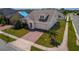 Well-maintained home featuring a two-car garage, brick driveway, neat landscaping, and a healthy young palm tree at 1720 Reflection Ln, St Cloud, FL 34771