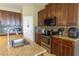 Granite countertops, stainless steel appliances, and dark wood cabinetry complete this modern kitchen at 1720 Reflection Ln, St Cloud, FL 34771