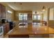Open-concept kitchen with granite counters, island, and dark wood cabinets leading into the living area at 1720 Reflection Ln, St Cloud, FL 34771