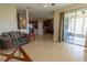 Open floor plan living room with tile floors and views of the kitchen and outdoor patio at 1720 Reflection Ln, St Cloud, FL 34771