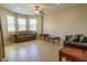 Bright living room with neutral paint, tile floor, ceiling fan, and natural light through windows at 1720 Reflection Ln, St Cloud, FL 34771