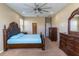 Spacious bedroom with carpet floors, ceiling fan, and ample closet space at 1720 Reflection Ln, St Cloud, FL 34771