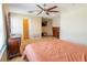 This main bedroom features neutral walls, carpet, a ceiling fan, and an en suite bathroom at 1720 Reflection Ln, St Cloud, FL 34771