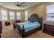 Large main bedroom with neutral tones, multiple windows, carpet floor, and elegant furnishings at 1720 Reflection Ln, St Cloud, FL 34771