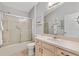 Bathroom featuring a glass shower door, neutral tones, and a vanity with ample counter space at 1139 Santa Cruz Dr, The Villages, FL 32162