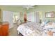 Well-lit bedroom featuring a ceiling fan, tile floors, and access to the sunroom at 1139 Santa Cruz Dr, The Villages, FL 32162