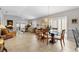 Open-concept living and dining area with tile floors, neutral walls, and sliding glass doors leading to the outdoors at 1139 Santa Cruz Dr, The Villages, FL 32162