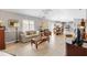 Open-concept living area with tile flooring, fan, and natural light flowing to the dining area at 1139 Santa Cruz Dr, The Villages, FL 32162
