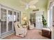 Relaxing sunroom with tiled floor, ceiling fan, and comfortable seating at 1139 Santa Cruz Dr, The Villages, FL 32162