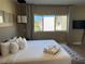 Relaxing bedroom with a plush king-size bed, and view of the surrounding community through the window at 3060 Rockefeller Way # 156, Kissimmee, FL 34747
