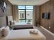 This bedroom features two twin beds, wood accent wall with a modern wall clock, and large window at 3060 Rockefeller Way # 156, Kissimmee, FL 34747