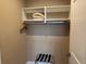 A closet with shelves, a hanging rod, and a convenient luggage rack offers storage solutions at 3060 Rockefeller Way # 156, Kissimmee, FL 34747