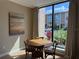 Cozy dining area with a round table and chairs, featuring a large window with a view of the outdoors at 3060 Rockefeller Way # 156, Kissimmee, FL 34747