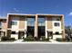 Modern two-story townhome with large windows and manicured landscaping at 3060 Rockefeller Way # 156, Kissimmee, FL 34747
