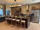 Spacious kitchen with large island, modern lighting, and stainless steel appliances at 3060 Rockefeller Way # 156, Kissimmee, FL 34747