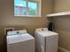 Bright laundry room featuring a Samsung washer and dryer at 3060 Rockefeller Way # 156, Kissimmee, FL 34747