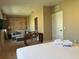 Spacious living area with a comfortable seating area and workspace, connected to a bedroom with a king-size bed at 3060 Rockefeller Way # 156, Kissimmee, FL 34747
