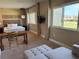 Spacious living room with sofa, chair, desk, and a bedroom with king bed offering a comfortable and stylish living space at 3060 Rockefeller Way # 156, Kissimmee, FL 34747