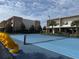 Brightly colored tennis court with yellow seating at 3060 Rockefeller Way # 156, Kissimmee, FL 34747