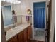 Well-lit bathroom features a vanity with storage and an accessible shower/toilet at 3405 Forsythe Ter, The Villages, FL 32162
