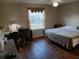 Comfortable bedroom featuring a well-lit desk and a window with bright natural light at 3405 Forsythe Ter, The Villages, FL 32162