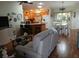 Inviting living room seamlessly flows into a spacious kitchen with a breakfast bar at 3405 Forsythe Ter, The Villages, FL 32162