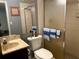 This bathroom features a toilet, sink, mirror, and standing shower at 3 Lakeside Dr, Ocala, FL 34482