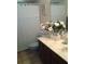 Bathroom featuring a tile floor, vanity and mirror with white roses at 3 Lakeside Dr, Ocala, FL 34482