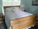 Cozy bedroom featuring a wooden bed frame with floral bedding, creating a peaceful and serene space at 3 Lakeside Dr, Ocala, FL 34482