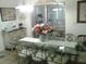 Bright dining room with a glass-top table, decorative chairs, and sliding glass doors to outside at 3 Lakeside Dr, Ocala, FL 34482
