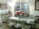 Dining room area with decorative chairs, glass table and flowers at 3 Lakeside Dr, Ocala, FL 34482