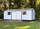 White storage shed with double doors at 3 Lakeside Dr, Ocala, FL 34482