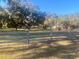 Sprawling front yard with fenced pasture and mature trees draped with Spanish moss at 3 Lakeside Dr, Ocala, FL 34482