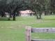 Ranch style home with tire swing in tree in large grass yard at 3 Lakeside Dr, Ocala, FL 34482