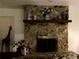 Detailed shot of the stone fireplace with wooden mantle creating a cozy and inviting living space at 3 Lakeside Dr, Ocala, FL 34482