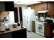 Traditional kitchen features wood cabinets, a white refrigerator, and tile floor at 3 Lakeside Dr, Ocala, FL 34482