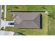 Aerial view of the home showcasing its roof, landscaping, and private driveway at 744 Osprey Roost Dr, Lakeland, FL 33801