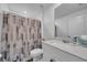 Bathroom with a patterned shower curtain, white vanity, and ample countertop space at 744 Osprey Roost Dr, Lakeland, FL 33801