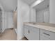 Modern bathroom boasts a large mirror, white cabinetry, and a walk-in shower at 744 Osprey Roost Dr, Lakeland, FL 33801