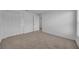 Bedroom featuring neutral carpet, a double door closet, and an open doorway at 744 Osprey Roost Dr, Lakeland, FL 33801