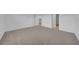 Spacious bedroom featuring neutral carpet, fresh white walls, and an open doorway at 744 Osprey Roost Dr, Lakeland, FL 33801
