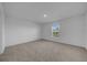 Brightly lit bedroom with neutral carpet and a window at 744 Osprey Roost Dr, Lakeland, FL 33801