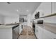 The kitchen features stainless steel appliances, white cabinetry, and stylish countertops at 744 Osprey Roost Dr, Lakeland, FL 33801