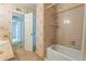 Bathroom featuring a patterned wallpaper, neutral carpet and a tub-shower combo at 159 Sweetgum Ln, Port Orange, FL 32129