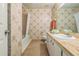 Cozy bathroom with patterned wallpaper, plush carpet, and a vanity with a marble-look countertop at 159 Sweetgum Ln, Port Orange, FL 32129