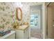 Bathroom with floral wallpaper, vanity, and view into the kitchen at 159 Sweetgum Ln, Port Orange, FL 32129