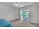 Small bedroom with carpet, adjacent balcony, and views of backyard at 159 Sweetgum Ln, Port Orange, FL 32129